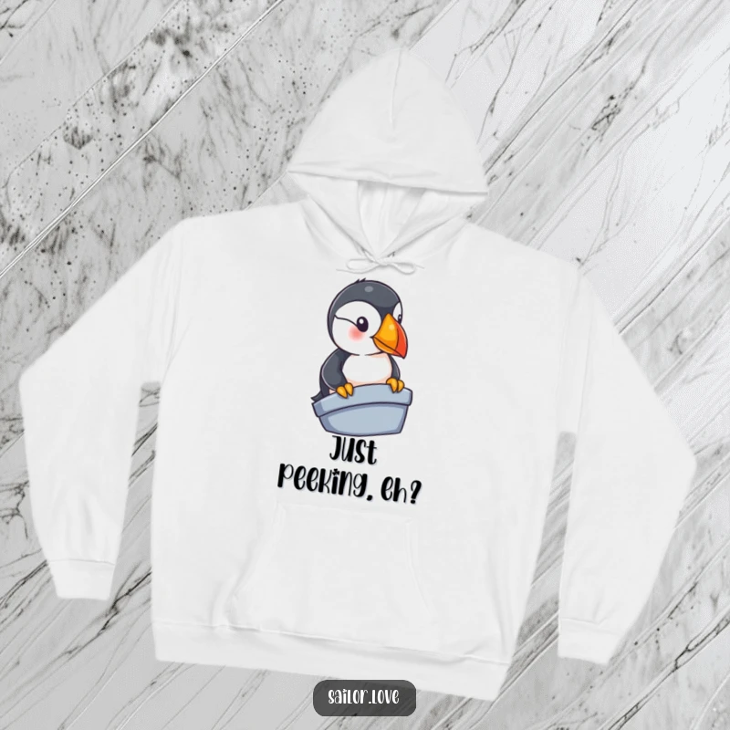 Funny puffin hoodie showing a curious bird looking over the edge of a small boat, depicting seafaring adventure and cute character humor.