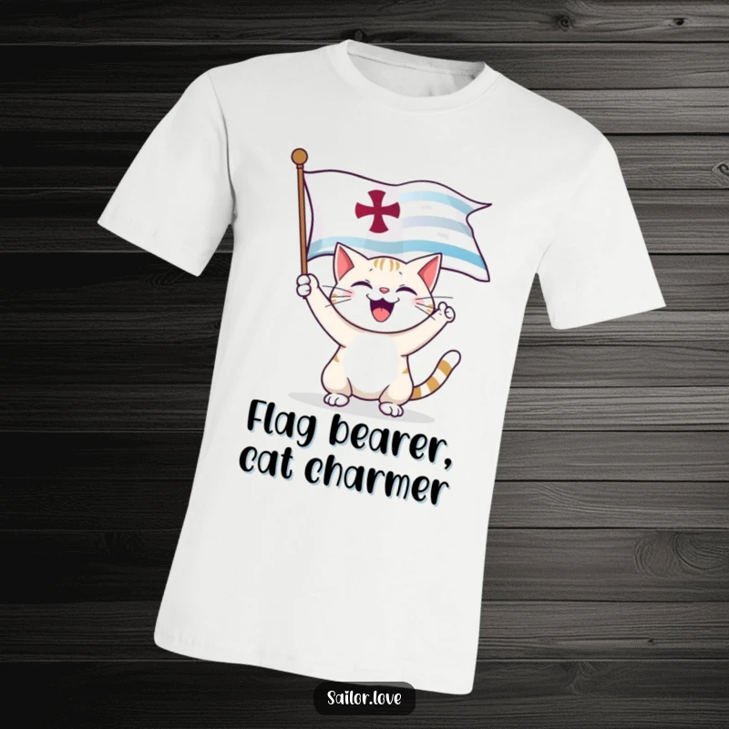 Funny T-Shirt: A happy cat joyfully unfurls a large nautical flag, showcasing its adventurous spirit.